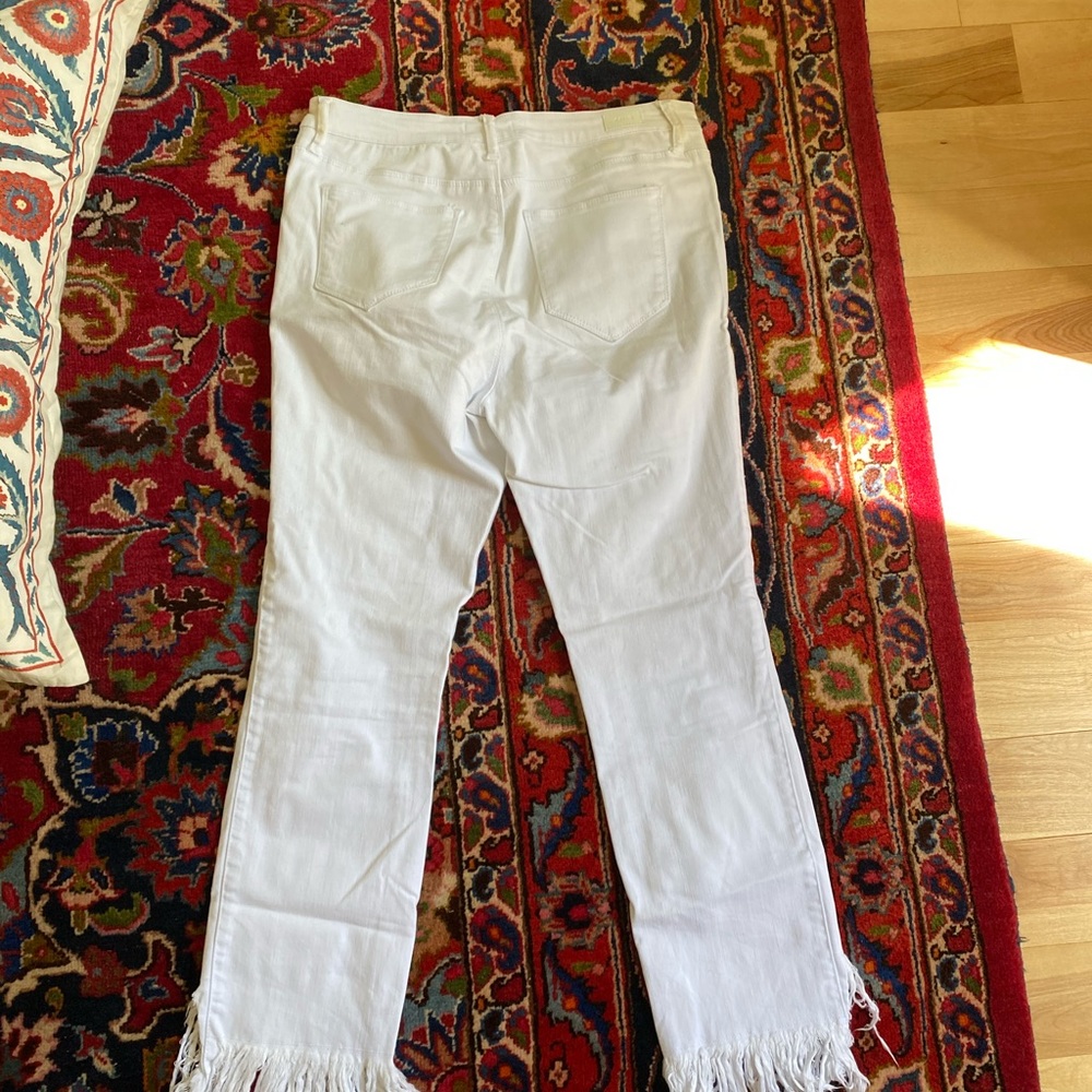 Ripped and frayed white jean